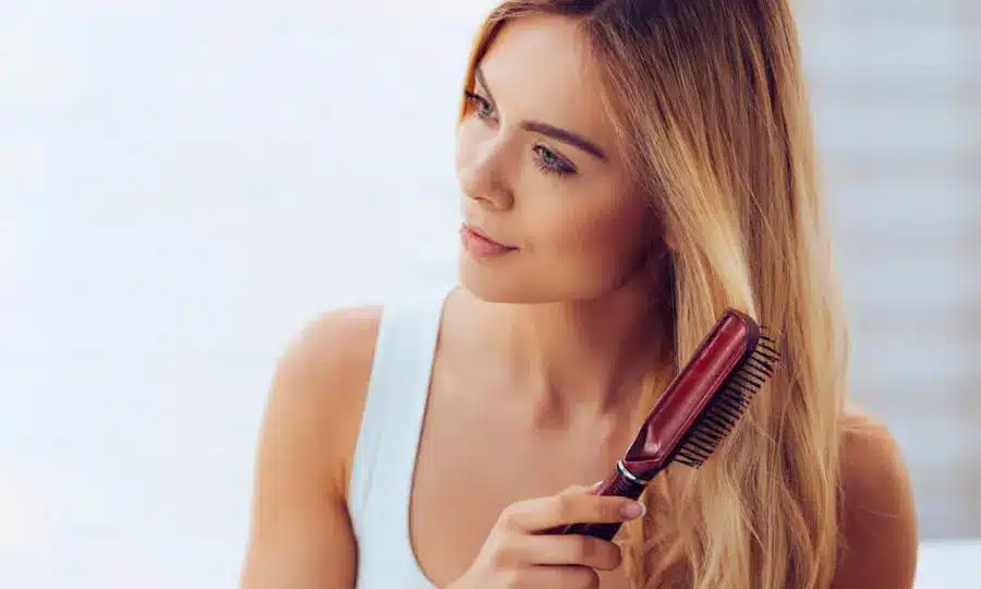 Het borstelen van het haar na gebruik van haarvezels